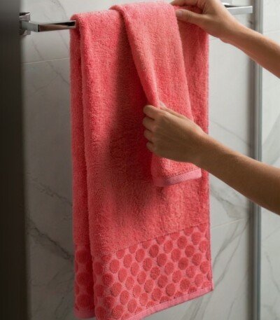 Pack de 2 serviettes de bain à pois en relief, coloris corail, 100 x 150 cm et 50 x 90 cm, 100 % coton